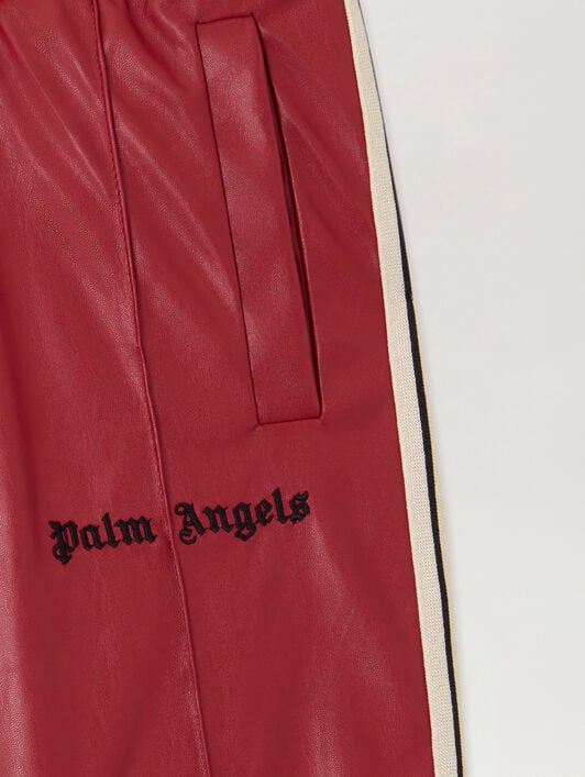 Coated Flare Track Pants PALM ANGELS Coated Flare Track Pants BRICK RED - BLACK PGCA023F25FAB001